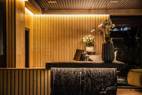 a lobby with a table with flowers in a vase at DAS ERZ Medical Spa & Hotel in Crottendorf