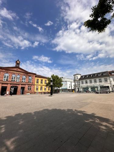 a city square with buildings and a blue sky at AMAO Obsidian - 120 m2 Business & Family Apartment - 3 Bedrooms - 8 Guests - King-Size Beds in Schwanau