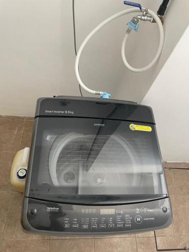 a laptop computer sitting on the floor next to a mouse at Arai HOMESTAY in Pusing