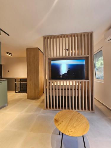 a living room with a large flat screen tv at Anja & Ogo apartments sea View & Pool in Petrovac na Moru