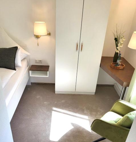 a bedroom with a bed and a desk and a chair at Haus im Herrengrund in Schollbrunn