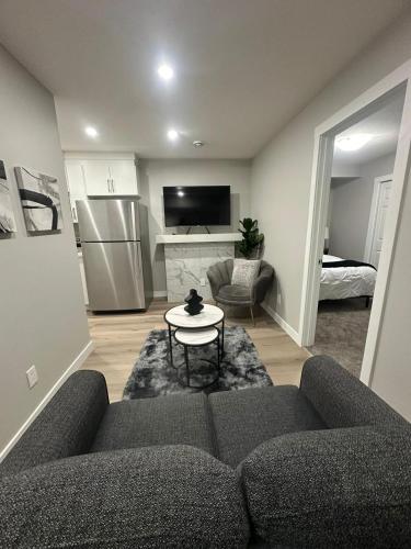 a living room with a couch and a table at Luxurious Home in NW Calgary, Free Parking, High Speed Internet, Near Grocery and Airport in Calgary