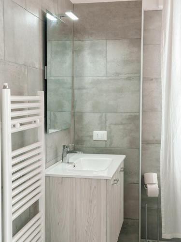 a bathroom with a sink and a mirror at Hotel Maremola in Pietra Ligure