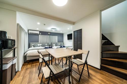 a bedroom with a bed and a table and chairs at 66, Omori-Nishi, Entire house for rent, 大森西 in Tokyo