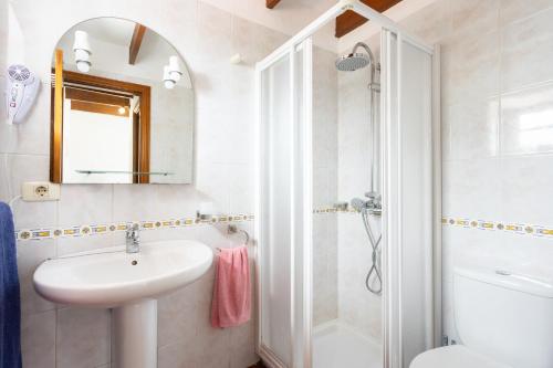 a white bathroom with a sink and a shower at Casa Rural Nina - Charming stay & Terrace, Hierro in El Pinar del Hierro