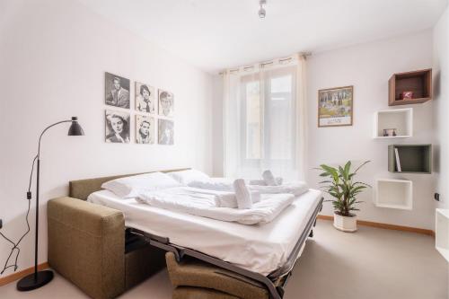 a white bedroom with a bed in a room at Casa Clara, old town experience in Riva del Garda