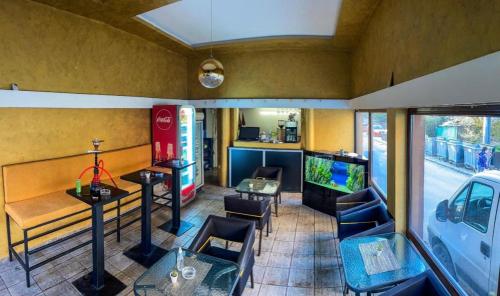 a restaurant with a table and chairs and a tv at Dreams Rooms in Dušanovac (historical)