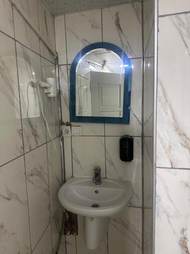 a bathroom with a sink and a mirror at Asya Hotel in Konya