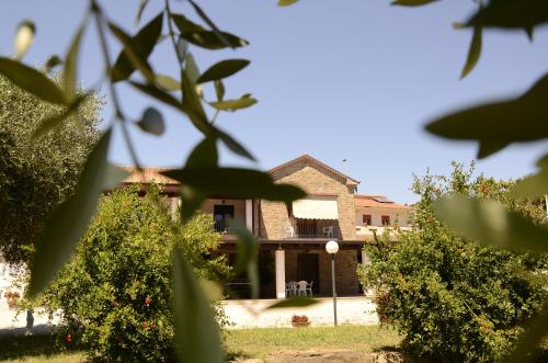 a view of a house from behind some trees at Country House Il Melograno in Castellabate