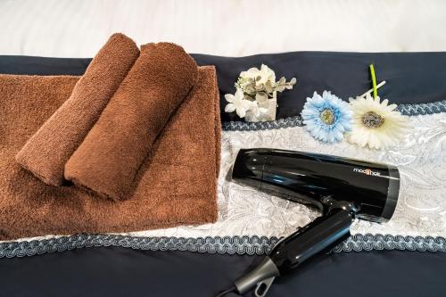 a close up of two towels and a hair dryer at 66, Omori-Nishi, Entire house for rent, 大森西 in Tokyo