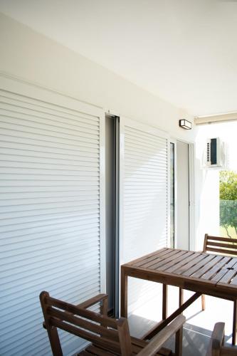 a room with a table and chairs and a window at Belair #Chalkidiki Lux App - Gerakini in Patelidhás