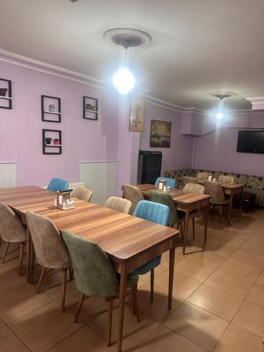 a dining room with wooden tables and chairs at Asya Hotel in Konya