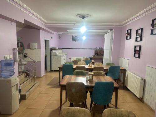 a dining room with tables and chairs and purple walls at Asya Hotel in Konya