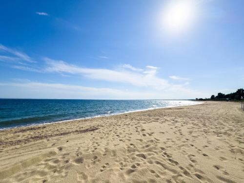 a beach with footprints in the sand and the ocean at Belair #Chalkidiki Lux App - Gerakini in Patelidhás