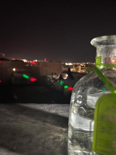 a bottle of water sitting on a table at night at Toys suites hotel in Eilat