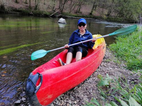 a woman in a red kayak on a river at Gaume Sweet Home in Moyen