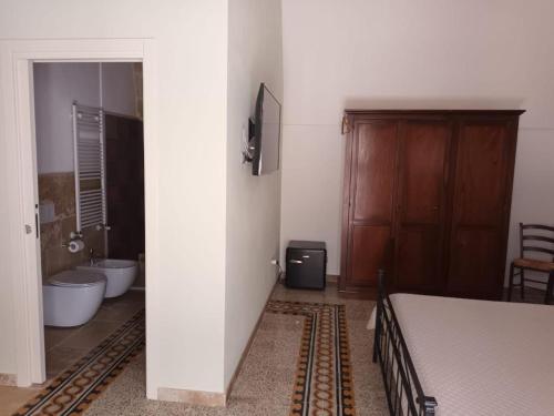 a bedroom with a bed and a tub and a sink at Dimora '900 in Poggiorsini