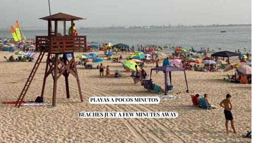 a group of people on a beach with umbrellas at Apartamento Babor Sun & Beach in Almerimar