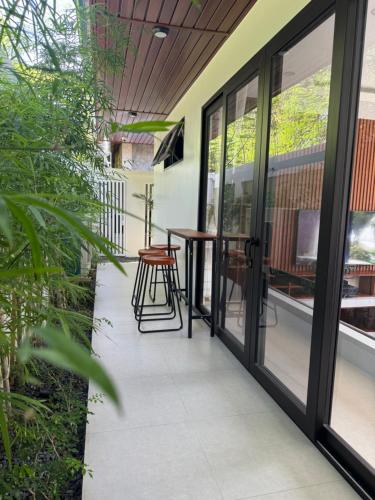 a patio with glass doors and a table and chairs at Villa Anela in Puerto Princesa City