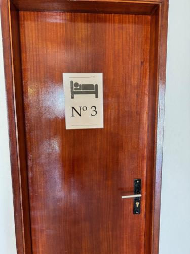 a wooden door with a sign on it at Guest House Casa Ramos on the Strip in Albufeira