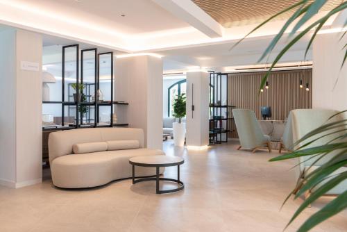 a living room with a couch and a table at Valentin Somni Hotel & Suites in Paguera