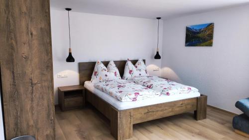 a bedroom with a bed with red and white pillows at Ferienhaus Steiner in Gries
