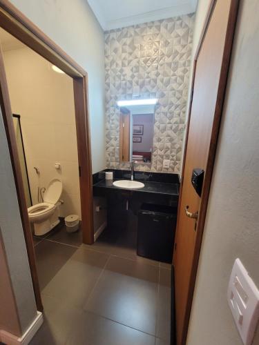 ein Bad mit einem Waschbecken und einem WC in der Unterkunft Pousada Recanto Luigi in Brotas