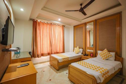 a hotel room with two beds and a television at Hotel Jaipur Inn !! Top Rated & Most Awarded Property in Jaipur in Jaipur