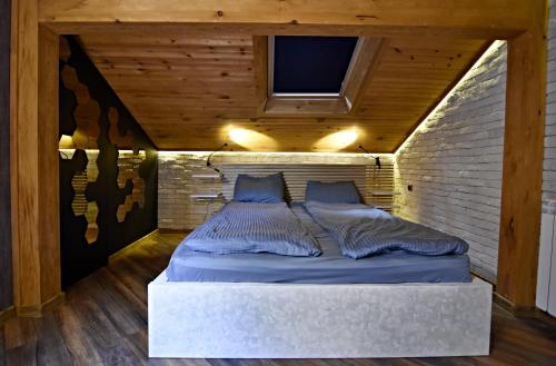 a bed in a room with a brick wall at Art Spa Villa Gal in Velingrad