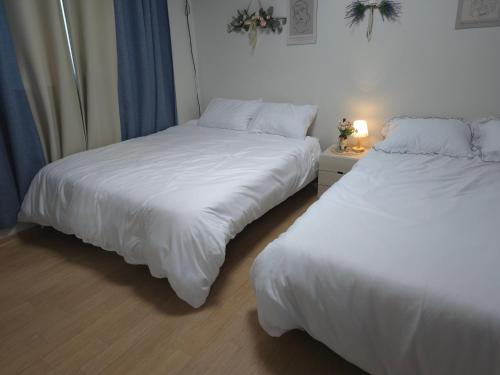 two beds sitting next to each other in a bedroom at HaengBok in Seoul