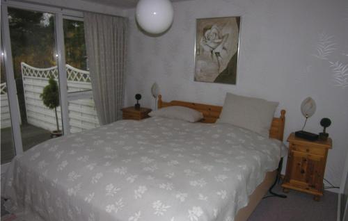 a bedroom with a white bed and a balcony at Bakketop in Balke