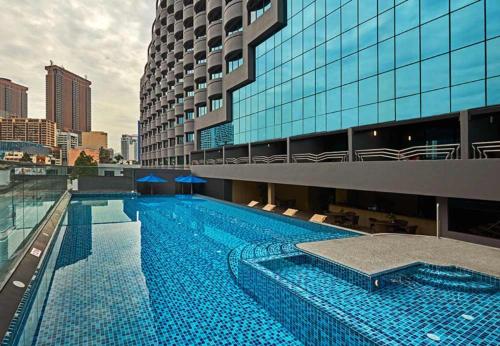 a large swimming pool in front of a building at Swiss Garden Residence in Kuala Lumpur