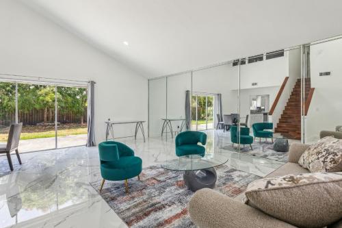 a living room with a couch and chairs and a table at Spacious 3BR Villa in Miami with Fenced Backyard in Miami