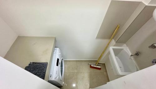a small bathroom with a toilet and a urinal at Rio Suits Apartments C in Posadas