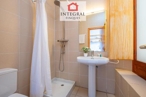 a bathroom with a sink and a toilet and a shower at Sal de Mar - Casa La Fosca in Palamós
