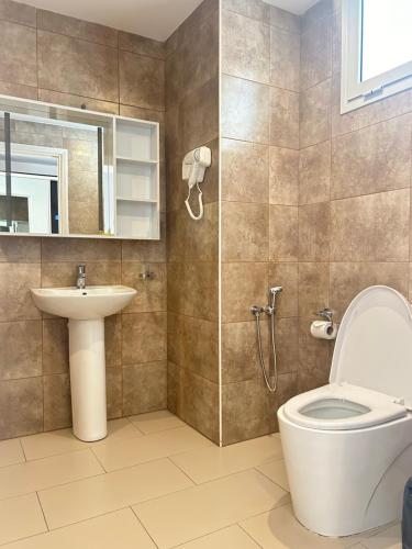 a bathroom with a toilet and a sink at ZARA HOTEL in Antananarivo