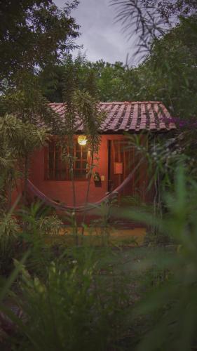 a small red house with a light on it at Pousada Donalu - Ótima Localização in Vale do Capao