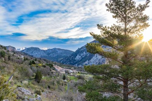 a view of a valley with a tree and mountains at Secluded home in Le Caunil in Salvezines