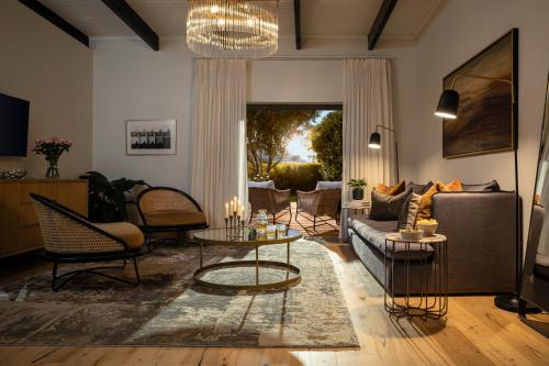 a living room with a couch and chairs at Steenberg Hotel & Spa in Tokai