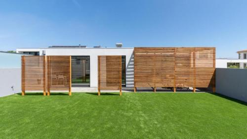 a house with a green lawn in front of it at Another Side in Furadouro
