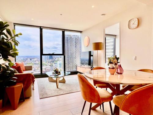 a living room with a table and a large window at Highrise view 1king1Queen 2baths in Melbourne