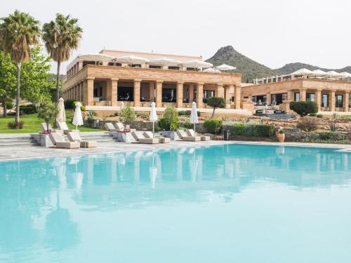 a large pool in front of a building at Cape Sounio Grecotel Boutique Resort in Sounio