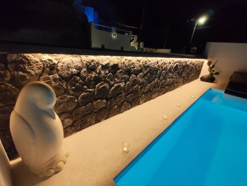 a villa with a swimming pool at night at The Magic Luxury Cave Suites in Vóthon