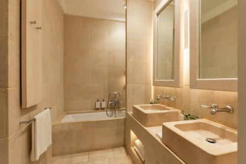 a bathroom with a sink and a bath tub at Borgo Egnazia in Savelletri di Fasano