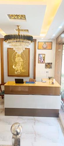 a reception desk in a room with a chandelier at HOTEL POLL STAR Inn in Barkot
