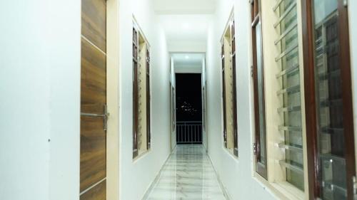 an empty hallway with paintings on the walls at HOTEL POLL STAR Inn in Barkot