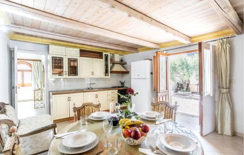 a kitchen with a table with a bowl of fruit on it at Villa Gladiolo in Marzamemi