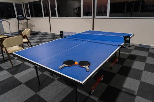 a ping pong table with two rackets and a ball on it at Flamingo Club and Resort Una 3 Km Away from Diu Check Post in Diu