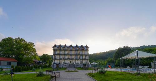 a large building sitting in the middle of a park at Hotel Shaori in Nikortsminda