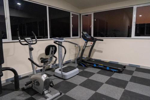 a gym with two treadmills and two exercise bikes at Flamingo Club and Resort Una 3 Km Away from Diu Check Post in Diu